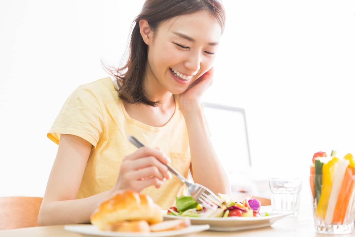 Woman eating and smiling